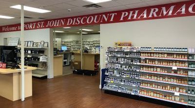 Interior aisles of Port St. John Discount Pharmacy lined with shelves of supplements